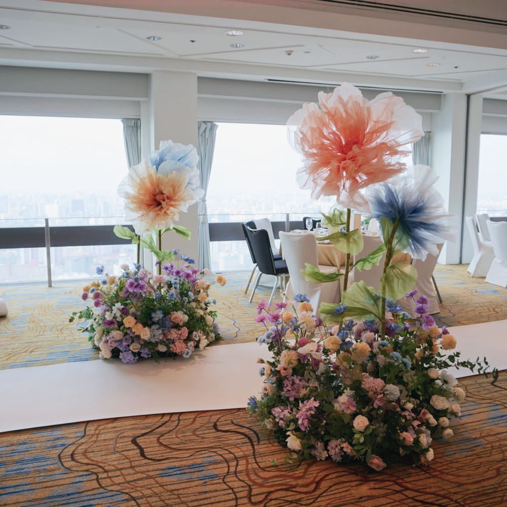 Our giant flowers paired with tall hedges and bubble lights are