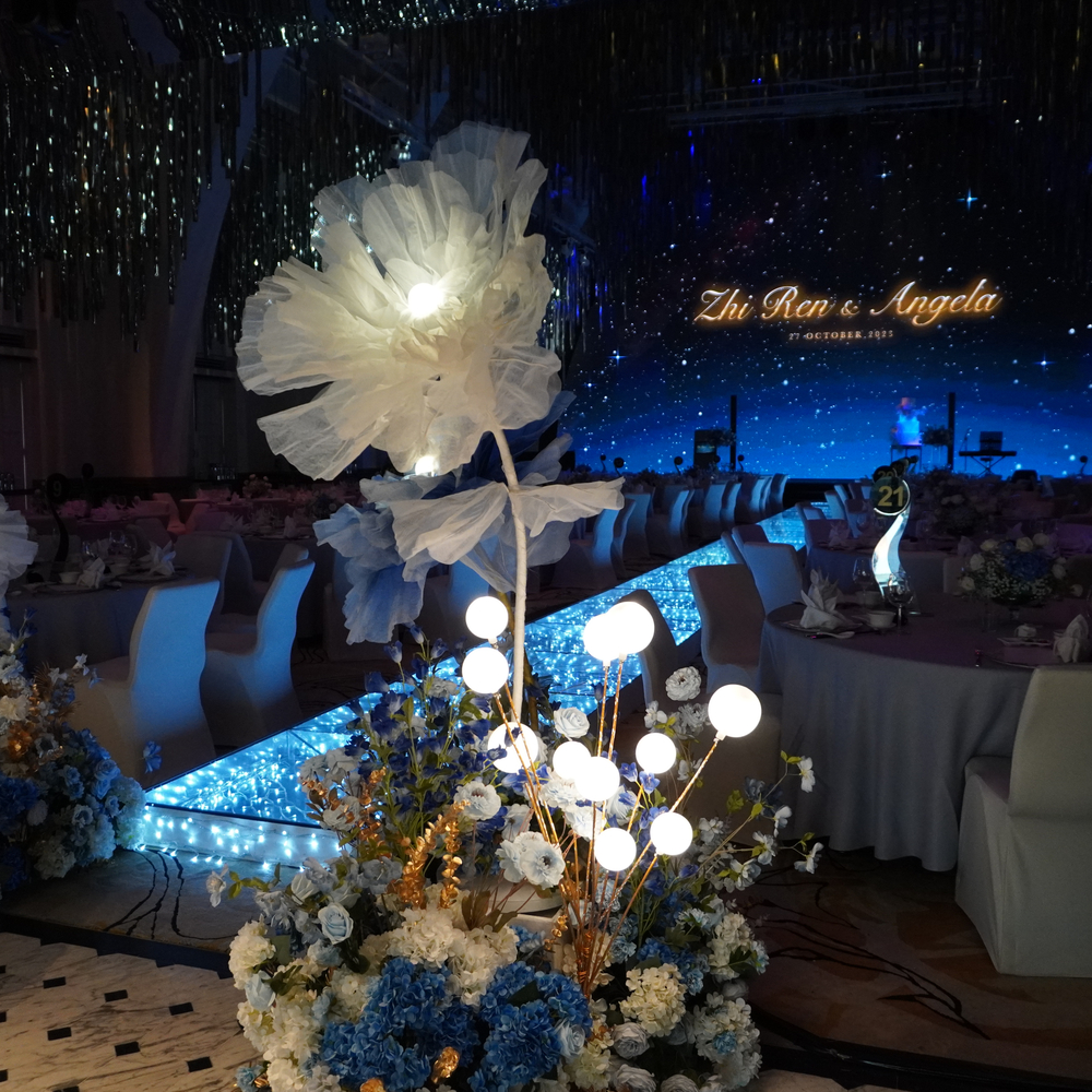 Our giant flowers paired with tall hedges and bubble lights are